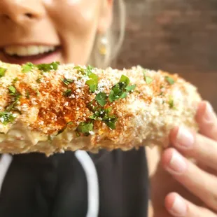 a woman holding a piece of food