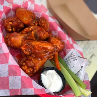 a basket of buffalo wings and celery