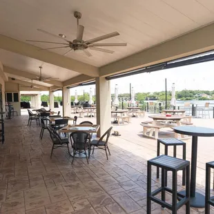 a patio area with tables and chairs