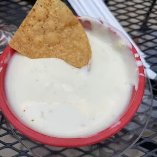 Cheese Dip Thick Queso with seasoned chips. Delicious!