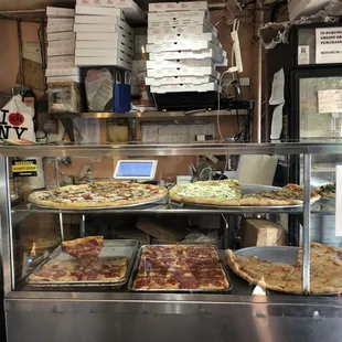 pizzas in a display case