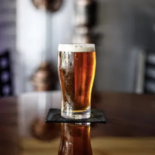 a glass of beer on a table