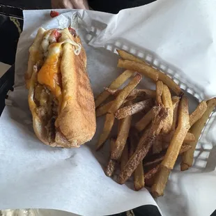 Bite taken out of the cheesesteak.. very cheesy. Fries were good too