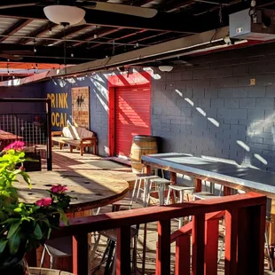 a patio with tables and chairs