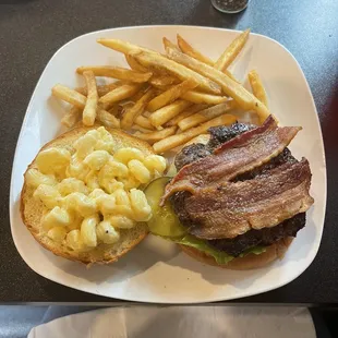 a plate of food including a burger, fries, and macaroni and cheese