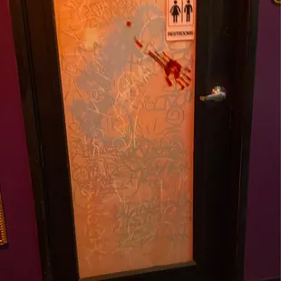 Bloody hand print on the bathroom door