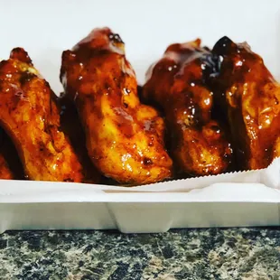 Chicken wings-Crisp, oven baked chicken wings tossed in our house honey gold inspired sauce will leave you longing for more.