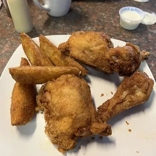 Part of the chicken dinner and potato wedges.