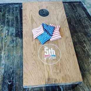 Play a game of cornhole