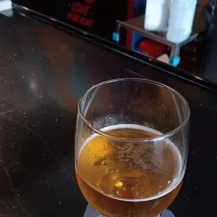 a glass of beer on a bar