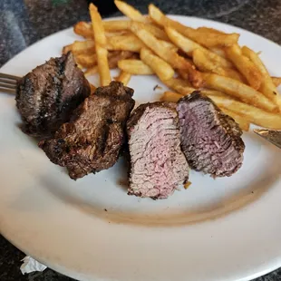 Beef tenderloin medallions, ordered medium, and fries