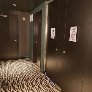 Inside restroom. 2 out of 6 stalls out of order.