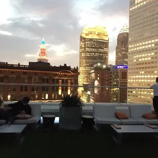 a group of people sitting on the roof of a building