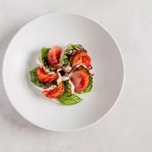 a white plate with a salad on it