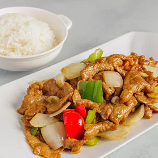 a plate of stir fried meat and vegetables