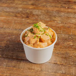 a bowl of food on a wooden table