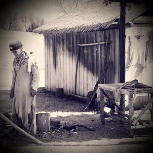 a man standing in front of a shack
