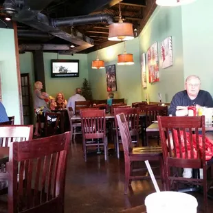 people sitting at tables in a restaurant