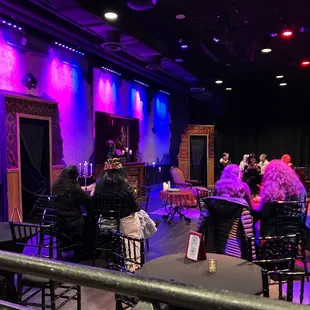 a stage with people sitting at tables