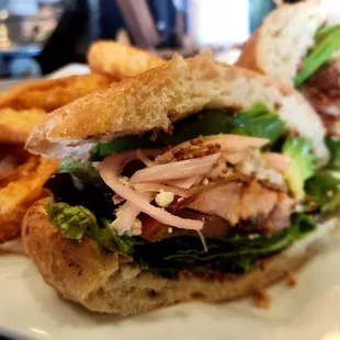 Black and Blue Salmon BLT: Blacked salmon topped with blue cheese, bacon, mixed greens, served on Cibatta bread (avocado added).