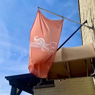 a red flag on the outside of the building