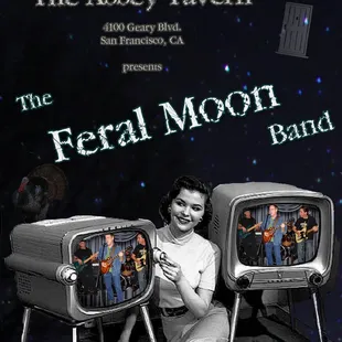 a woman sitting in front of two televisions