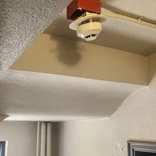 Fire alarms hanging by their wires.
