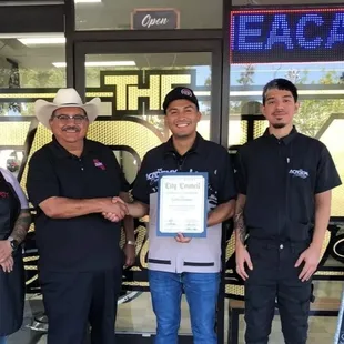 Recognized for providing free ‍cuts at the Back to School event. Mayor Santos G, Owner/Barber Carlos G, Barber Matt G, Barber Ana M.