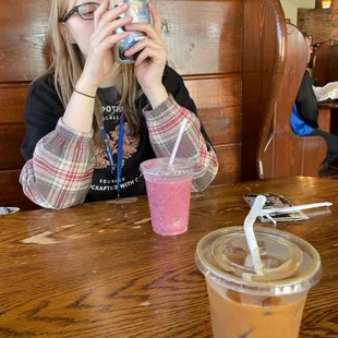 a woman taking a picture of her drink