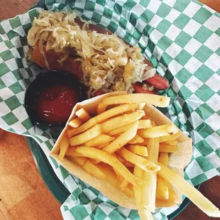 All beef kraut hot dog with a side of fries.
