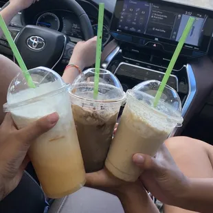 two people holding drinks in their hands