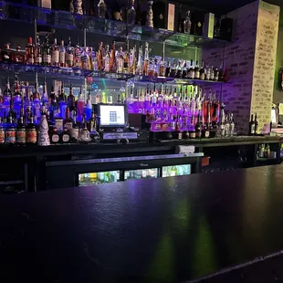 a bar with many bottles of alcohol