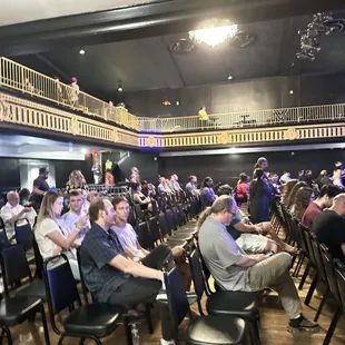 a large group of people sitting in chairs