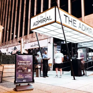 people standing outside of a restaurant