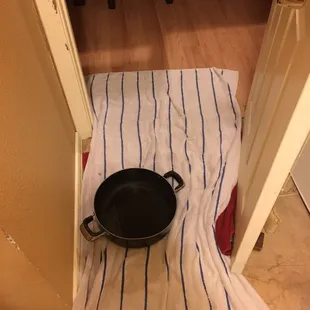 Pot on the floor to catch water from the leak in our roof.