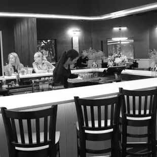 a woman sitting at a bar