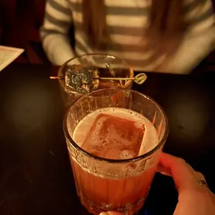 a person holding a glass of beer