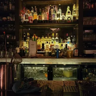 a bar with bottles of alcohol on the shelves