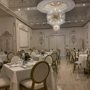 a formal dining room with a chandelier