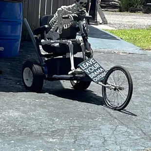 a skeleton riding a tricycle