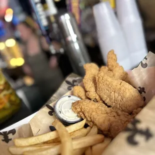 a basket of fried chicken and french fries