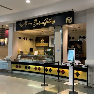 In spite of the lighted sign that says "open" they are located in a food court, and the booth looks deserted.