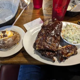 Full Rack of Ribs with coleslaw and a loaded baked potato