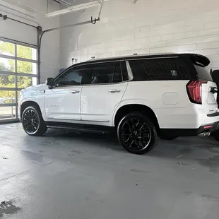 Two to vehicle wrap gloss black and pearl white.