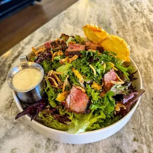 Steak Salad: blackened Steak served over Mixed Greens, Smoked Gouda, Mozzarella, Roasted Red Bell Peppers, Onion, Candied Walnuts