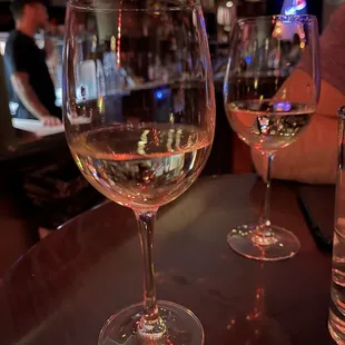 three wine glasses on a bar