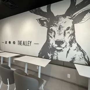tables and chairs in front of a deer