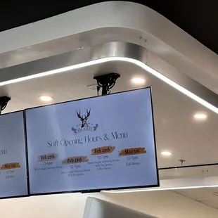 two television screens displaying the menu