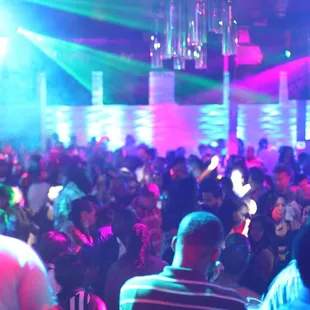 a crowd of people dancing at a nightclub