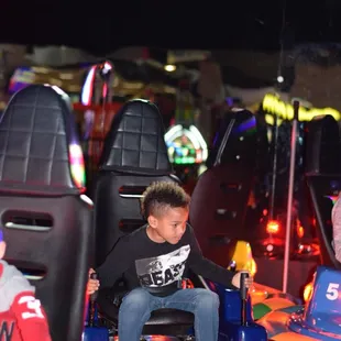 a young boy in a bumper car